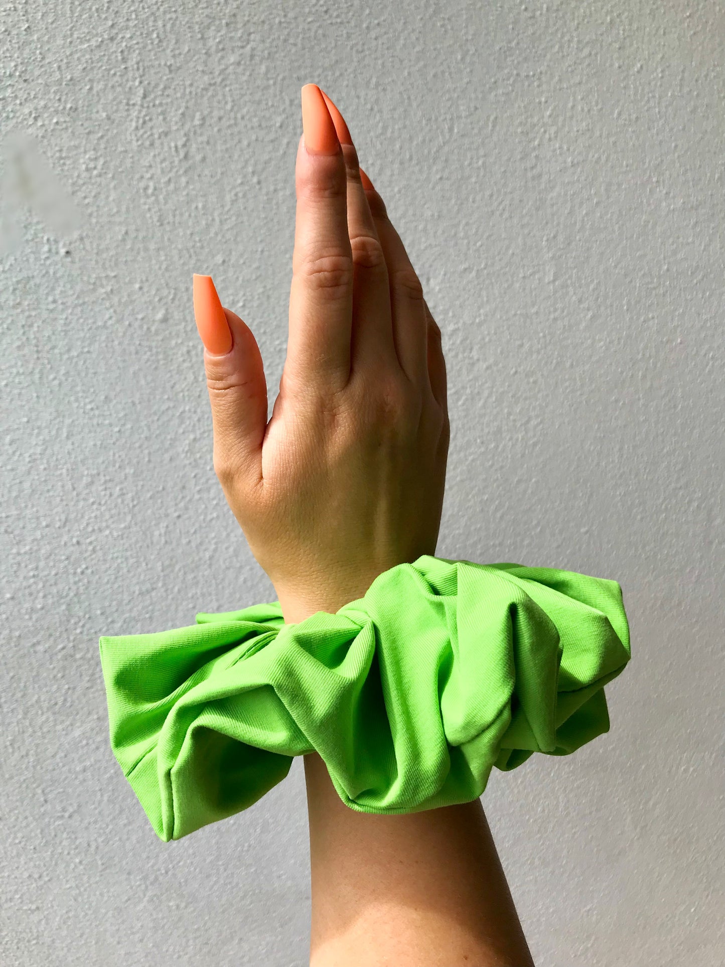 large neon green scrunchie and neon nails